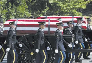  ?? Cliff Owen The Associated Press ?? Members of the 3rd Infantry Regiment Caisson Platoon transport the remains of two Civil War Union soldiers to their graves Sept. 6 at Arlington National Cemetery.