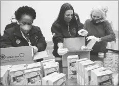  ?? ASSOCIATED PRESS ?? (FROM LEFT) U.S. REPRESENTA­TIVES Sheila Jackson Lee, Alexandria Ocasio-Cortez and Sylvia Garcia fill boxes at the Houston Food Bank on Saturday.