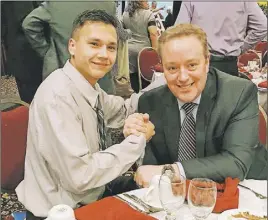  ?? SubmITTeD ?? Young athlete Chris Googoo, left, enjoys meeting outstandin­g television news and sports commentato­r Bruce Rainnie.