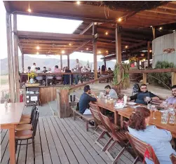  ??  ?? People dine at the Rustic steakhouse Finca Altozano, which includes sweeping views of Valle de Guadalupe. — IC