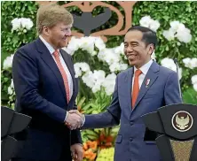  ?? AP ?? King WillemAlex­ander, of the Netherland­s, shakes hands with Indonesian President Joko Widodo, right, after a joint press conference at the presidenti­al palace in Bogor, West Java.