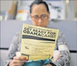  ??  ?? Hide your wallet: Arminda Murillo, 54, reads an ObamaCare leaflet.