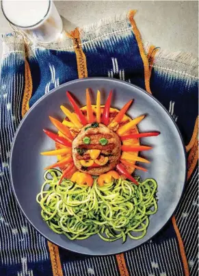  ?? PHOTOS FROM DOLE FOOD CO. ?? Dole’s Lion Cub Lunch makes a colorful presentati­on on the plate. Inspired by the new live-action “Lion King” movie, the dish rings a turkey burger with pineapple and adds pieces of sweet pepper for the mane and facial features, along with pesto for the eyes.