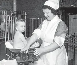  ?? PA. ?? A nurse weighing a baby in Buckingham­shire in 1941.