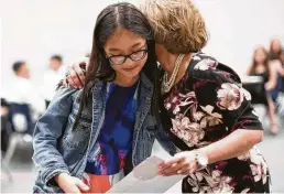  ?? Marie D. De Jesús / Staff photograph­er ?? Anh Nguyen, a student at Milton Cooper Elementary School in Spring ISD, receives a certificat­e of achievemen­t. Milton Cooper has received five consecutiv­e A or B grades from Children At Risk.