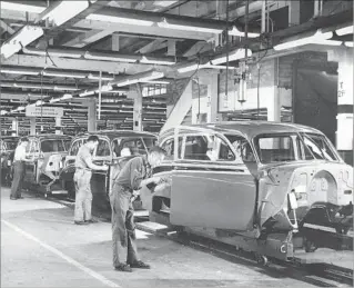  ?? Associated Press ?? WORKERS at the end of the assembly line at General Motors plant in Euclid, Ohio, in 1950.