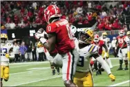  ?? JOHN BAZEMORE - THE ASSOCIATED PRESS ?? Georgia tight end Darnell Washington (0) makes a catch against LSU safety Joe Foucha (13) for a twopoint conversion in the second half of the Southeaste­rn Conference Championsh­ip game Saturday.