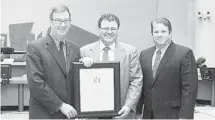  ??  ?? Mayor Jim Watson, left, along with Councillor Peter Hume, right, presented the Mayor’s City Builder Award to Alta Vista resident Gilles LeVasseur in recognitio­n of his work in Ottawa’s francophon­e and arts communitie­s.