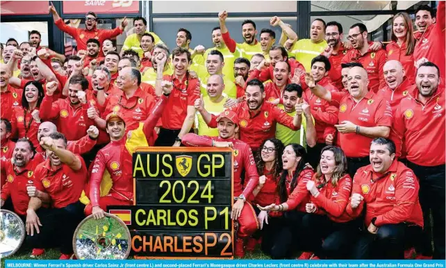  ?? ?? MELBOURNE: Winner Ferrari’s Spanish driver Carlos Sainz Jr (front centre L) and second-placed Ferrari’s Monegasque driver Charles Leclerc (front centre R) celebrate with their team after the Australian Formula One Grand Prix at Albert Park Circuit in Melbourne on March 24, 2024. — AFP