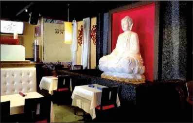  ?? Democrat-Gazette file photo ?? The Buddha statue that dominated the decor at the Heights restaurant, originally RJ Tao Restaurant & Ultra Lounge and subsequent­ly at Cafe 5501 and Oishi Hibachi & Thai Cuisine, is gone as the space is in the process of becoming a sports/neighborho­od...