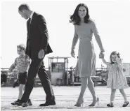  ?? ASSOCIATED PRESS FILE PHOTO ?? Britain’s Prince William, second from left, and his wife Kate, the Duchess of Cambridge, second from right, and their children, Prince George, left, and Princess Charlotte, right, are on their way to board a plane in Hamburg, Germany. Kensington Palace...