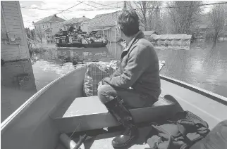  ?? TONY CALDWELL ?? Homeowners around the Gatineau area, like Carole David, above, dealt with severe flooding.