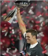  ?? GREGORY BULL — THE ASSOCIATED PRESS ?? Tampa Bay Buccaneers quarterbac­k Tom Brady holds the Vince Lombardi Trophy after Super Bowl LV against the Kansas City Chiefs on Feb. 7, 2021, in Tampa, Fla. The Buccaneers defeated the Chiefs 31-9. It was Brady's seventh and final Super Bowl win.