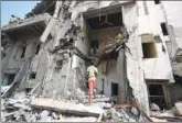  ?? ABDULJABBA­R ZEYAD / REUTERS ?? A boy looks at a damaged house at the site of a Saudi-led airstrike