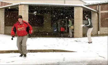  ?? Times photograph­s by Annette Beard ?? Above: Teachers Matt Easterling and Chris Wann enjoyed a bit of levity with a snowball fight Tuesday morning.