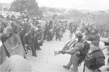  ?? JOSE LUIS MAGANA/ AP ?? U. S. Capitol Police push back demonstrat­ors who were trying to enter the building on Wednesday. Despite many warning signs on pro- Trump demonstrat­ions, the agency did not increase staffing and didn’t prepare for a possible riot.