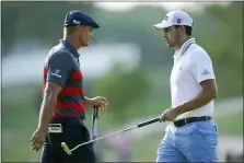  ?? JULIO CORTEZ — THE ASSOCIATED PRESS ?? Patrick Cantlay, right, walks by Bryson DeChambeau after he sank his putt on the 17th green during the final round of the BMW Championsh­ip golf tournament, Sunday at Caves Valley Golf Club in Owings Mills, Md.
