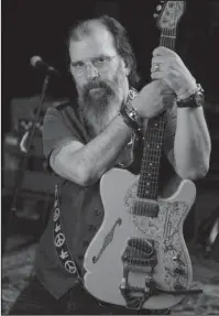  ?? The Associated Press ?? OUTLAW: Grammy-winning songwriter Steve Earle poses in a rehearsal studio on June 8 in Nashville, Tenn. When Earle first arrived in Nashville from Austin in the ’70s, he was the young gun among a group of veteran singer-songwriter­s. It was the...