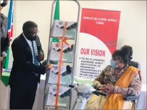  ?? Photo: Wilhelmina Iimene ?? Inclusivit­y… Auditor general Junias Kandjeke launches the braille informatio­n booklet with deputy minister of disability affairs Alexia Manombe-Ncube.