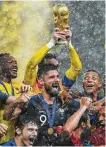  ?? Jewel Samad / AFP/Getty Images ?? France adds the 2018 World Cup trophy to the one it collected in Paris in 1998.