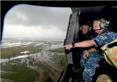  ?? PHOTO: FAIRFAX ?? Australian Chief of the Defence Force Air Marshal Mark Binskin with Labor leder Bill Shorten look at the damage below from an army helicopter. Prime Minister Malcolm Turnbull and Shorten visited the cyclone damaged area of Bowen in north Queensland yesterday.