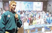  ?? PHOTO: SIMON HENDERSON ?? Team effort . . . Nasa astronaut Colonel Michael Hopkins is flanked by a slideshow image of some of the Nasa Johnson Space Centre team that he used during a public presentati­on at the Alexandra Memorial Hall yesterday.