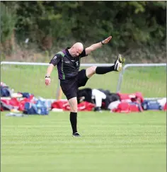  ??  ?? The referee gets his stretching done ahead of the clash in Tinahely.