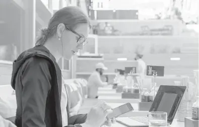  ?? JACQUELYN MARTIN/AP ?? Baylee Bowers pays for her lunch using her cellphone Sept. 2 at Bartaco in Arlington, Va. The restaurant is using an automated app for ordering and payments. Instead of servers they use“food runners”to get orders to tables.