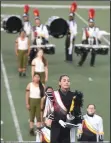  ?? BEA AHBECK/ NEWSSENTIN­EL ?? Lodi High Marching Band drum major Erin Redding stands at the beginning of its performanc­e.