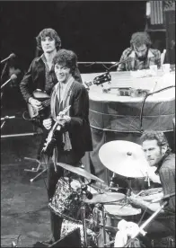  ?? AP ?? The Band (counterclo­ckwise from top right), Richard Manuel on piano, Levon Helm on drums, lead guitarist Robbie Robertson and bass guitarist Rick Danko, take the stage for their final live performanc­e before a crowd at Winterland Auditorium in San Francisco on Nov. 27, 1976.