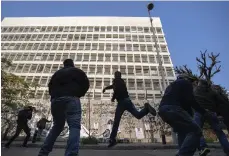  ?? AP ?? Protesters throw stones at the central bank and rally against Mr Salameh and the deepening financial crisis in Beirut