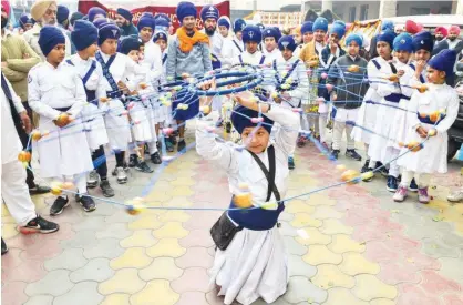  ?? Agence France-presse ?? A young Sikh demonstrat­es his ‘Gatka’ traditiona­l martial art skills during the ‘Nagar Kirtan’ procession ahead of the birth anniversar­y of the 10th Sikh Guru Gobind Singh in Amritsar on Friday.