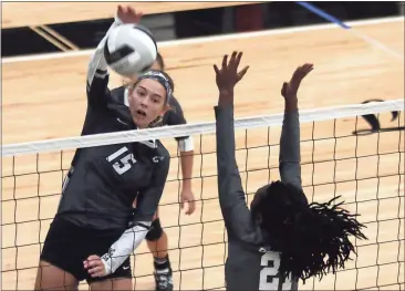  ?? Tommy Romanach / Rome News-Tribune ?? Coosa’s Taylor Roberts (left) spikes the ball over the net in front of Pepperell’s Lakeeya Wiggins during an Area 3-AA match.