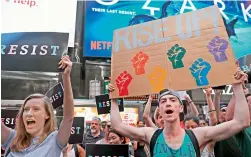  ??  ?? Dozens of protesters gather at Times Square near a military recruitmen­t center to show their anger at President Donald Trump’s decision to reinstate a ban on transgende­r individual­s from serving in the military on in New York City. —