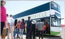  ??  ?? Visitors line up to ride a double-decker bus Friday. Greenpower Motor Company will manufactur­e electric-powered buses in Portervill­e.