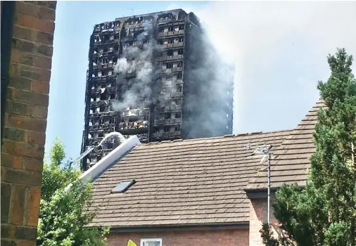  ??  ?? Smoke rises from the 24-story Grenfell Tower after a blaze early on Wednesday morning. (Photo: Charlie Neyra/Arab News)