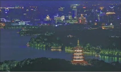  ?? WANG XIAOBO / FOR CHINA DAILY ?? West Lake is lit up at night in Hangzhou, Zhejiang province, where the G20 Leaders Summit will be held on Sept 4 and 5.