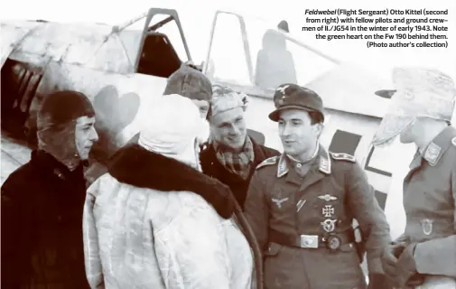  ?? ?? Feldwebel (Flight Sergeant) Otto Kittel (second from right) with fellow pilots and ground crewmen of II./JG54 in the winter of early 1943. Note the green heart on the Fw 190 behind them. (Photo author’s collection)