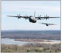  ?? (Arkansas Democrat-Gazette/Tony Holt) ?? C-130Js fly in formation Saturday during a training exercise over Central Arkansas. More photos at arkansason­line.com/38flight/.