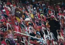  ??  ?? San Francisco 49ers mascot Sourdough Sam poses for a photo while surrounded by cutouts of fans during a game against the Arizona Cardinals at Levi’s Stadium on Sept. 13.