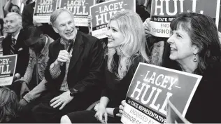  ?? Yi-Chin Lee / Staff photograph­er ?? Gov. Greg Abbott records a video with conservati­ve activist Lacey Hull, center, a candidate for Texas House District 138, during a campaign event in Houston last week.