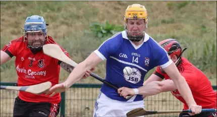  ??  ?? Podge Doran of Oylegate-Glenbrien bursting past Oulart-The Ballagh duo Dennis Morton and Eamon Murphy.