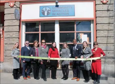  ?? LAUREN HALLIGAN - MEDIANEWS GROUP ?? A ribbon cutting ceremony is held on March 7for the one-year anniversar­y of Community Miracles in Action.