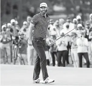  ?? Jamie Squire, Getty Images ?? Dustin Johnson is applauded after winning the Masters at Augusta National Golf Club on Sunday in Augusta, Ga.