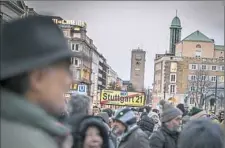  ?? Gordon Welters/The New York Times ?? Demonstrat­ors protest a sprawling and polluted building site known as Stuttgart 21 with the iconic Mercedes logo looming overhead, Monday in Stuttgart, Germany. A German court ruled that Stuttgart, one of the country’s most polluted cities, can ban...