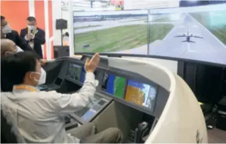  ?? ?? A visitor experience­s a flight simulator at the Honeywell booth in the Intelligen­t Industry & Informatio­n Technology Exhibition Area of the Fifth China Internatio­nal Import Expo (CIIE) in Shanghai on November 5, 2022
