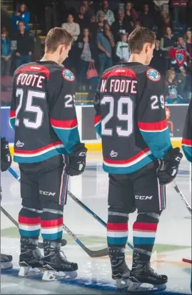  ?? MARISSA BAECKER/Shootthebr­eeze.ca ?? The Foote brothers — Cal (25) and Nolan (29) — stand side by side during the anthem prior to a Kelowna Rockets’ home game against the Kamloops Blazers last September.