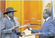  ?? REUTERS ?? South Sudan’s rebel leader Riek Machar, right, and South Sudan President Salva Kiir exchange a signed peace agreement document.