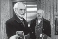  ?? CP PHOTO ?? Former Knowledge House Inc. president and CEO Daniel Potter, left, speaks to reporters at the courthouse in Halifax on Friday. Potter and lawyer Blois Colpitts were found guilty in a multi-million-dollar stock market fraud case.