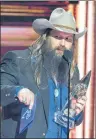  ?? AP PHOTO ?? In this file photo, Chris Stapleton accepts the award for album of the year “From A Room: Volume 1” at the CMA Awards at the Bridgeston­e Arena, in Nashville, Tenn.